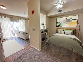 Salt Lake City apartment for rent - Liberty Citywalk Apartments, Salt Lake City, Utah, studio apartment with half wall, showing a full-size bed looking into the kitchen and living room.