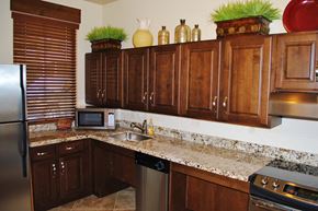 Ogden townhouse for rent - a kitchen with wooden cabinets and granite counter tops