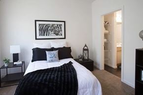 Staunton apartment for rent - A bedroom with a large bed and a painting on the wall.
