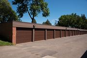 New Hope apartment for rent - a row of garages with a parking lot and trees