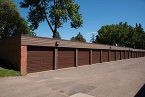 New Hope apartment for rent - a row of garages with a parking lot and trees