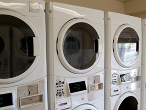 Rexburg apartment for rent - a row of washing machines in a laundry room
