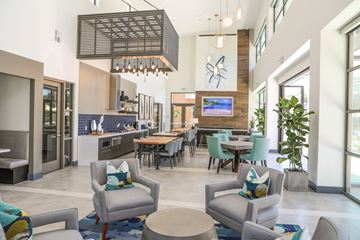 Sacramento apartment for rent - a living room with couches and chairs and a kitchen with a table and chairs