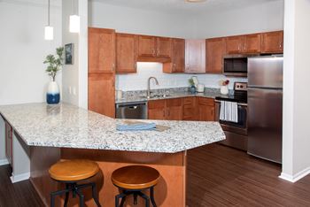 Large kitchen with cabinetry and appliances