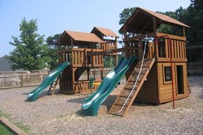 Knightdale townhouse for rent - a playground with three slides and a swing set