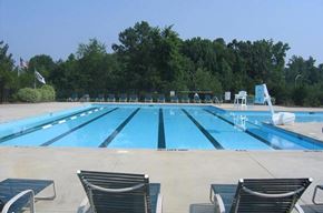 Knightdale townhouse for rent - a large swimming pool with chairs around it