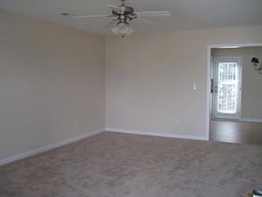 Knightdale townhouse for rent - an empty living room with a ceiling fan
