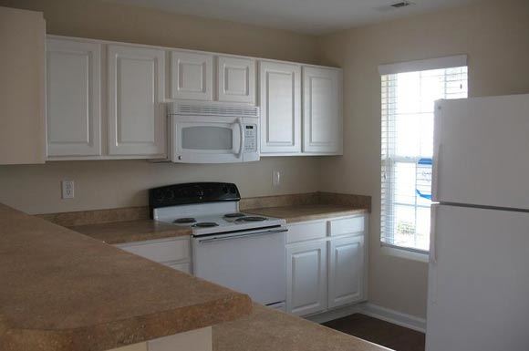 Knightdale townhouse for rent - a kitchen with white appliances and white cabinets