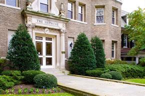 Washington apartment for rent - a large brick building with trees and bushes in front of it