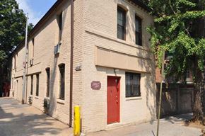 Washington apartment for rent - a white brick building with a red door