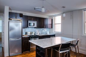 Washington apartment for rent - a kitchen with stainless steel appliances and a marble counter top