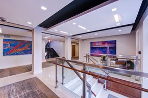 Washington apartment for rent - a large lobby with a staircase and paintings on the wall