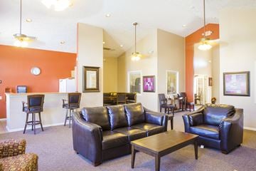 Gurnee apartment for rent - a living room with couches and chairs and a kitchen with a bar