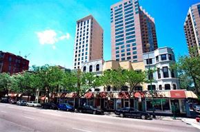 Chicago apartment for rent - a city street with cars parked in front of tall buildings