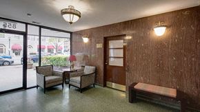 Evanston apartment for rent - a lobby with chairs and a table and a glass door
