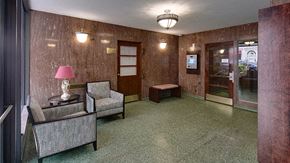 Evanston apartment for rent - a lobby with two chairs and a lamp and a glass door