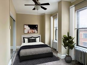 Chicago apartment for rent - a bedroom with a bed and a ceiling fan