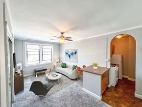 Chicago apartment for rent - a living room with a white couch and a ceiling fan
