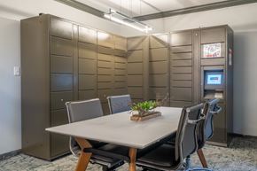 Chicago apartment for rent - a conference room with a white table and chairs and stainless steel lockers