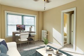 Chicago apartment for rent - a living room with a couch and a desk with a computer
