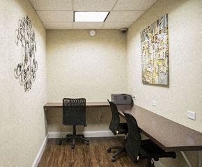 Chicago apartment for rent - a conference room with a desk and chairs and a printer
