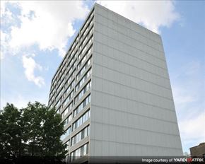 Chicago apartment for rent - A tall building with a lot of windows and a tree in front.
