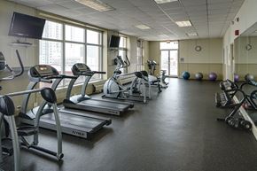 Chicago apartment for rent - a gym with cardio equipment and weights in a building