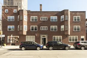 Philadelphia apartment for rent - a brick building with three cars parked in front of it