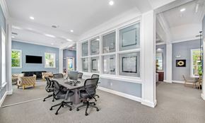 Nashville apartment for rent - a conference room with a table and chairs and a wall of windows
