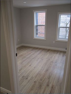 Waterloo apartment for rent - A room with light wood flooring and two windows.