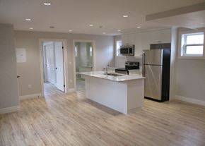 Waterloo apartment for rent - A kitchen with a white island and black refrigerator.