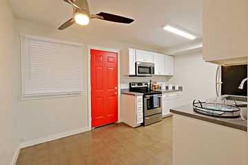 Phoenix apartment for rent - a kitchen with a red door and a stove and refrigerator