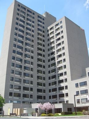 Rochester apartment for rent - a tall building with a tree in front of it