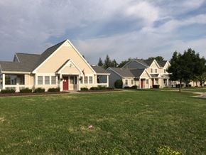 Rochester townhouse for rent - a row of houses in front of a green field