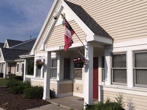 Rochester townhouse for rent - a flag hanging on the side of a house