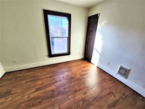 Rochester townhouse for rent - a empty living room with wood floors and a window