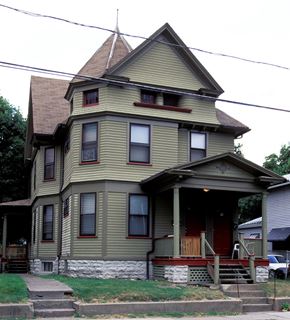 Rochester townhouse for rent - a yellow house with a steeple on the corner of a street