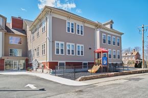 Uxbridge apartment for rent - a building with a playground in front of it