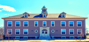 Uxbridge apartment for rent - a large pink house with blue sky in the background