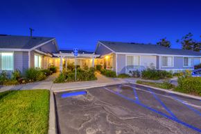 Midway City apartment for rent - a parking lot in front of some houses at night