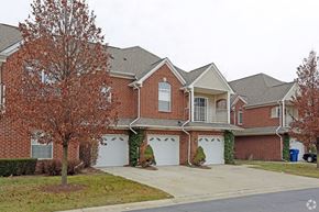 Shelby Twp apartment for rent - a red brick house with white garage doors