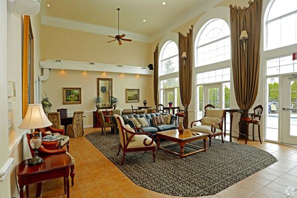 Shelby Twp apartment for rent - a living room filled with furniture and large windows