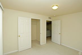 Shelby Twp apartment for rent - a bedroom with two closets and a door to a bathroom