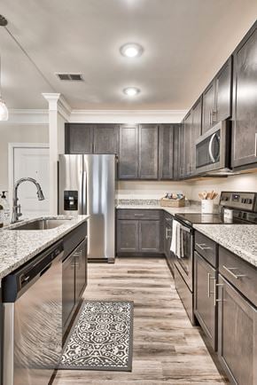 Clayton apartment for rent - A modern kitchen with dark wood cabinets and stainless steel appliances.