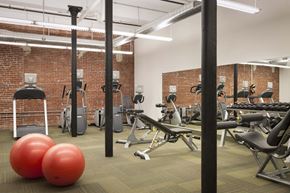 Lowell apartment for rent - A gym with a variety of equipment including weights and exercise balls.