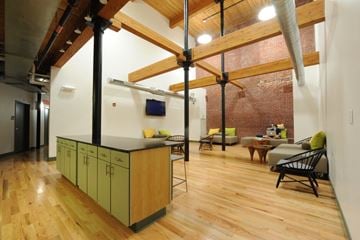 Lowell apartment for rent - A kitchen with wooden floors and a green island.