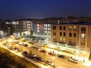 Lowell apartment for rent - A parking lot is lit up at night in front of a building with a sign that says "how to open a marijuana dispensary.".