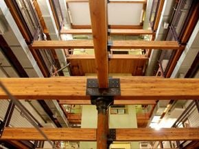Lowell apartment for rent - A wooden beam structure with a black metal bracket in the middle.