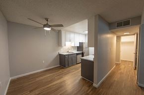 South Lake Tahoe apartment for rent - an empty living room and kitchen with a ceiling fan