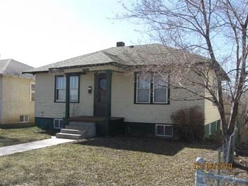 Scottsbluff house for rent - a white house with a yard and a tree